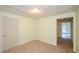 Bright bedroom with neutral carpet, light walls, and doorway leading to a tiled room offers versatile living at 410 Hendon Rd, Woodstock, GA 30188
