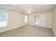 Large carpeted bedroom with ample natural light from two windows, creating a bright and open space at 410 Hendon Rd, Woodstock, GA 30188