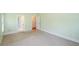 Large bedroom with neutral carpet, trim, and walls, with views into the attached bath at 410 Hendon Rd, Woodstock, GA 30188