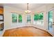 Cozy breakfast nook with hardwood floors, large windows, and access to the deck at 410 Hendon Rd, Woodstock, GA 30188