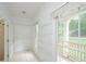 Bright walk-in closet features shelving, a window to the porch, and access to the bathroom at 410 Hendon Rd, Woodstock, GA 30188