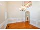 Elegant dining room with hardwood floors, wainscoting, a chandelier, and access to a staircase at 410 Hendon Rd, Woodstock, GA 30188