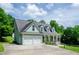 Charming two-story home with a two-car garage, covered porch, and well-manicured lawn at 410 Hendon Rd, Woodstock, GA 30188