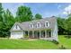 Lovely home with a welcoming front porch and a well-maintained lawn, plus a convenient two-car garage at 410 Hendon Rd, Woodstock, GA 30188
