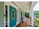 Inviting front porch featuring rocking chairs, a decorative door, and views of the surrounding greenery at 410 Hendon Rd, Woodstock, GA 30188