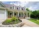 Charming front porch with rocking chairs, pillars, and a colorful door; perfect for relaxing outdoors at 410 Hendon Rd, Woodstock, GA 30188