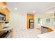 Bright kitchen featuring white tile floors, wood cabinets, and stainless steel appliances at 410 Hendon Rd, Woodstock, GA 30188