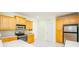 Bright kitchen featuring white tile floors, wood cabinets, and stainless steel appliances at 410 Hendon Rd, Woodstock, GA 30188
