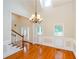Bright living room featuring hardwood floors, a chandelier, staircase, and large windows at 410 Hendon Rd, Woodstock, GA 30188