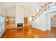 Inviting living room featuring a fireplace, built-in shelving, a staircase and hardwood floors at 410 Hendon Rd, Woodstock, GA 30188