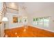 Bright living room featuring hardwood floors, staircase and open access to the kitchen and dining areas at 410 Hendon Rd, Woodstock, GA 30188