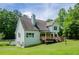Back of the home features a private wooden deck and a spacious lawn, perfect for outdoor living at 410 Hendon Rd, Woodstock, GA 30188