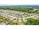 Expansive aerial shot of a community featuring numerous homes, green spaces, and dense surrounding woods at 8553 Braylen Manor Dr, Douglasville, GA 30134