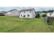 Large, grassy backyard with a two-story home in the background at 8553 Braylen Manor Dr, Douglasville, GA 30134