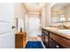 Bathroom with double vanity, bath and shower with white tile and built in shelves at 8553 Braylen Manor Dr, Douglasville, GA 30134