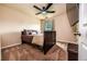 Bedroom with a ceiling fan, window, and a bed with brown bedding at 8553 Braylen Manor Dr, Douglasville, GA 30134
