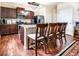Modern kitchen featuring dark wood cabinetry, granite countertops, stainless steel appliances, and a central island at 8553 Braylen Manor Dr, Douglasville, GA 30134