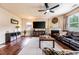 Inviting living room with hardwood floors, fireplace, large TV, and plush seating for relaxing evenings at 8553 Braylen Manor Dr, Douglasville, GA 30134