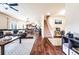 Spacious open-concept living room with hardwood floors, staircase, and seamless flow into the kitchen at 8553 Braylen Manor Dr, Douglasville, GA 30134