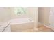 Bright bathroom features soaking tub, window, and natural light at 10074 Tara Glynn Dr, Hampton, GA 30228