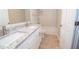 Bright bathroom features a double vanity with granite countertops and tiled floors at 10074 Tara Glynn Dr, Hampton, GA 30228