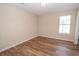 Bright bedroom with natural light from the window and continuous wood-style flooring at 10074 Tara Glynn Dr, Hampton, GA 30228