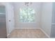 Bright dining area with large windows and neutral tile floors and walls at 10074 Tara Glynn Dr, Hampton, GA 30228
