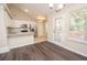 Cozy dining area with white cabinets, granite countertops, and stainless steel appliances at 10074 Tara Glynn Dr, Hampton, GA 30228