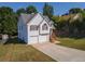 Two-story home with a two-car garage, traditional shutters, and a well-kept lawn at 10074 Tara Glynn Dr, Hampton, GA 30228