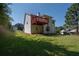 Back exterior view of a two-story home with a wooden deck and spacious yard at 10074 Tara Glynn Dr, Hampton, GA 30228