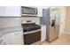 Close up of a kitchen features stainless steel appliances, white cabinets, and granite countertops at 10074 Tara Glynn Dr, Hampton, GA 30228