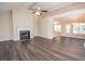 Spacious living room with modern floors, a fireplace, and an open layout with lots of natural light at 10074 Tara Glynn Dr, Hampton, GA 30228