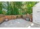 Fenced backyard with large concrete patio, greenery, and access gate at 10900 Wittenridge Dr # C7, Alpharetta, GA 30022
