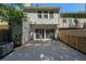 Two-story home's fenced backyard with concrete patio and sliding glass doors at 10900 Wittenridge Dr # C7, Alpharetta, GA 30022