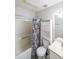 Cozy bathroom offers a shower-tub combo, patterned shower curtain, and storage shelves at 10900 Wittenridge Dr # C7, Alpharetta, GA 30022