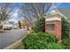 Community entrance with brick signage and mature landscaping in The Preserve at 10900 Wittenridge Dr # C7, Alpharetta, GA 30022