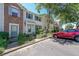 View of the townhome's exterior, showcasing a red car parked in front of it at 10900 Wittenridge Dr # C7, Alpharetta, GA 30022
