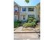 Charming townhome featuring a partial brick facade, blue shutters, and landscaped front yard at 10900 Wittenridge Dr # C7, Alpharetta, GA 30022