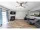 Bright living room featuring a fireplace, hardwood floors, and natural light streaming through the sliding door at 10900 Wittenridge Dr # C7, Alpharetta, GA 30022