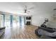 Spacious living room with hardwood floors, fireplace, and access to the outdoor patio at 10900 Wittenridge Dr # C7, Alpharetta, GA 30022
