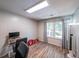 Bright office space features wood flooring, a large window, and space for a desk at 10900 Wittenridge Dr # C7, Alpharetta, GA 30022