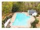 Large community pool surrounded by well maintained landscaping and a shaded lounge area for residents at 10900 Wittenridge Dr # C7, Alpharetta, GA 30022
