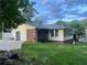 Back exterior featuring an enclosed porch, backyard access, and newly installed siding at 1321 Earle Se Ct, Conyers, GA 30013
