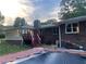 Backyard with a wooden deck, a covered pool and a brick home at 1321 Earle Se Ct, Conyers, GA 30013