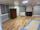 Basement with new light fixture and wood-look flooring, showcasing storage options and an electric fireplace at 1321 Earle Se Ct, Conyers, GA 30013