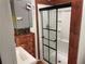 Updated bathroom featuring a new shower with black trim, wood accents, and a tankless hot water system at 1321 Earle Se Ct, Conyers, GA 30013