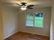 Inviting bedroom with a ceiling fan, natural light and stylish laminate wood flooring at 1321 Earle Se Ct, Conyers, GA 30013