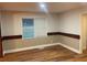 Bedroom features decorative trim, hardwood floors, and a window for natural light at 1321 Earle Se Ct, Conyers, GA 30013