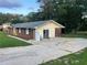 Exterior of a single-story home with a long driveway and a mix of brick and siding at 1321 Earle Se Ct, Conyers, GA 30013
