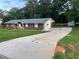 Well-maintained home with long driveway, a brick facade, and a backyard storage shed at 1321 Earle Se Ct, Conyers, GA 30013